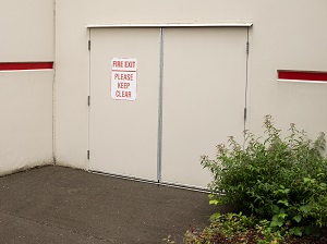 Fire Exit Doors, View from Outside Facility, Clearly Marked with Sign that Says Please Keep Clear
