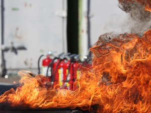Large Fire with Fire Extinguishers Seen in the Distance