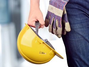 Construction Worker Holding Hard Hat with Gloves