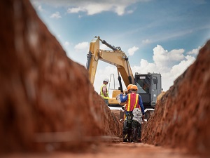 Two Workers in Trench on Construction Site