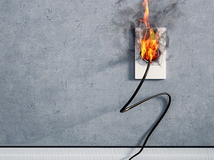 Extension Cord Plugged into Wall Socket on Fire