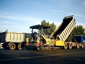 Workers Laying New Asphalt in Work Zone