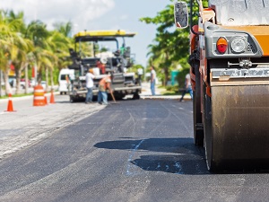 Roller and Heavy Equipment Laying New Asphalt for Street