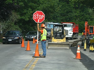 Work Zone Flagger Holding Stop Sign Directing Traffic