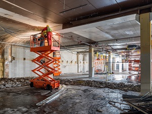 Construction Workers Using Scissor Lift to Work on Ceiling