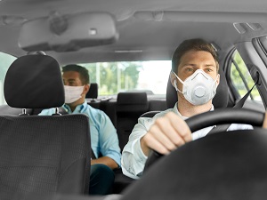 Two People in Car Both Wearing Masks