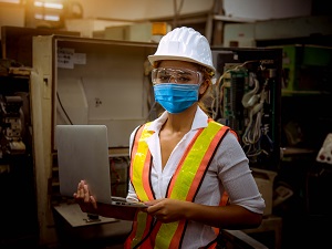 Industrial Worker Wearing Hardhat, Safety Vest and Face Mask