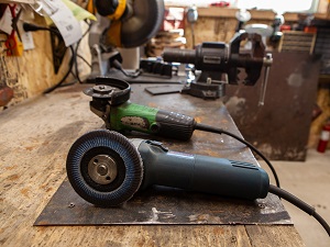 Two Portable Grinders on Work Bench