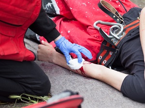 Injured Worker is Bleeding, Laying on Ground, Receiving First Aid
