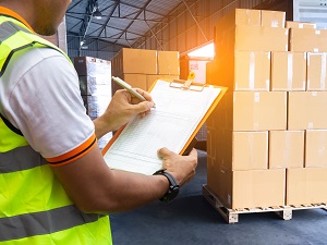 Warehouse Worker Completing Inventory in Warehouse