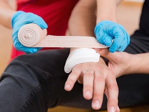 Person getting first aid for a laceration on the hand.