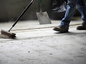 Worker Wearing Work Boots, Sweeping Up Floor