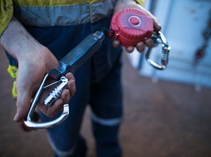 A worker demonstrating how a snap hook works.