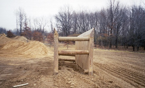 The trench shield that was in the trench the day before was removed with an excavator and placed 20 yards from the trench. It was not put back in the trench when work resumed the next day.