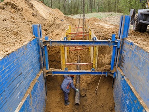 Deep trench with cave-in protection added.