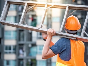 Construction Worker Carrying Step Ladder