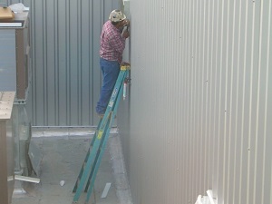 Construction worker has leaned step ladder up against a wall like an extension ladder, dangerous