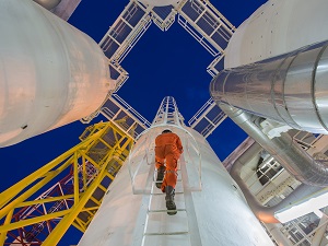 Engineer climbing up a fixed ladder.