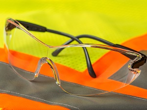 Safety glasses laying on a safety vest.