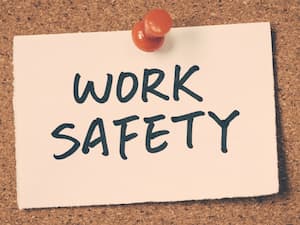Note pinned to a corkboard with the words 'Work Safety' written in bold letters.