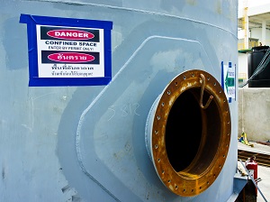 Entry to a confined space with a danger sign visible.