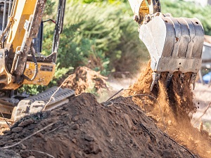 Excavator digging dirt out of the ground