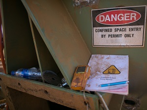 A sign that says Danger, Confined Space Entry by Permit Only.