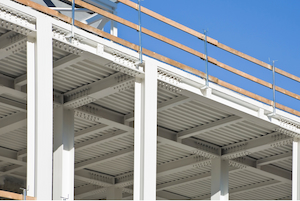 Temporary guardrail system installed along the edge of a steel structure.