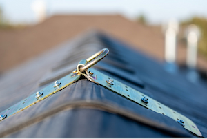 Roof anchor point installed on a metal roof for fall protection equipment.