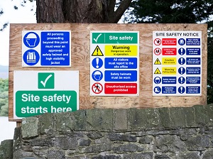 Signs at the entrance of a construction site.