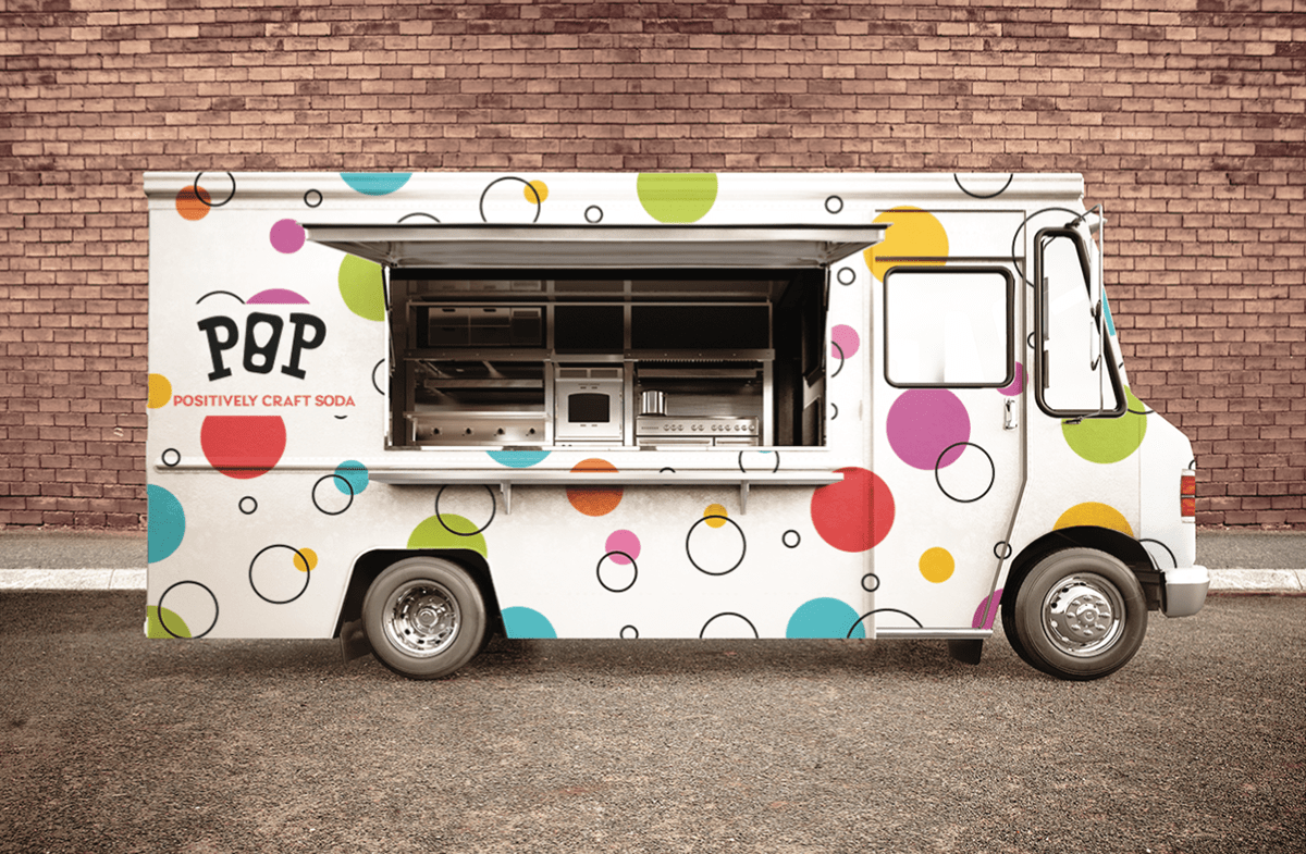 Pop food truck outside of a brick building
