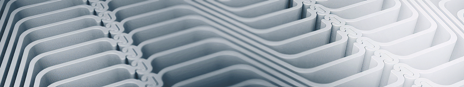 Close-up of interlocking, curved, white plastic or metal panels forming a geometric pattern.