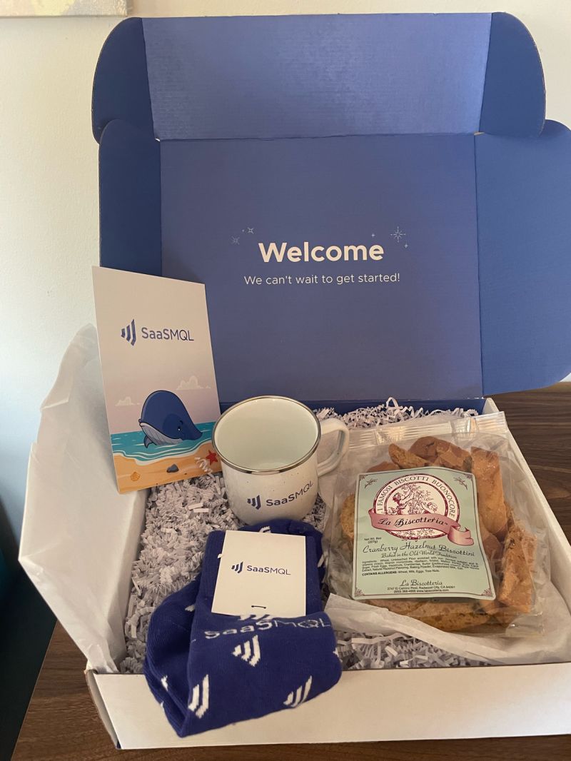 SaaSMQL welcome box with branded items and Italian treats