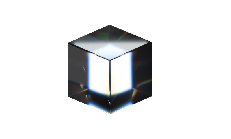 Transparent glass cube reflecting light with prismatic color effects on edges.