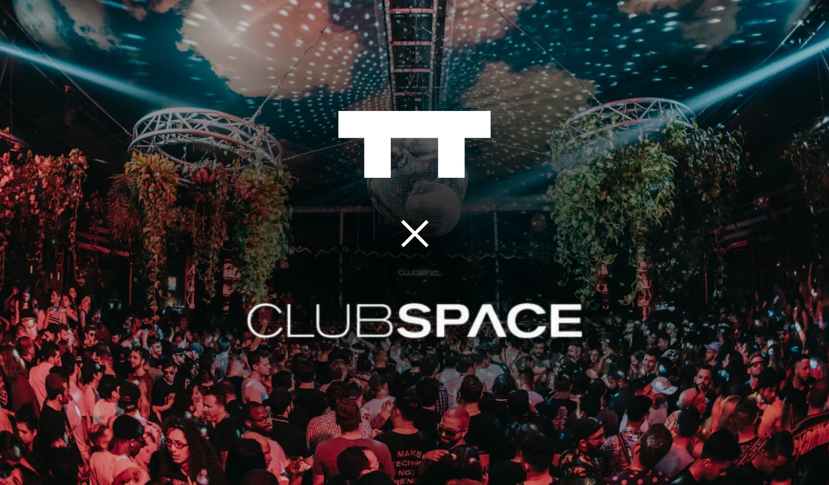Crowded nightclub with hanging plants, disco balls, colorful lights, and people dancing and socializing.