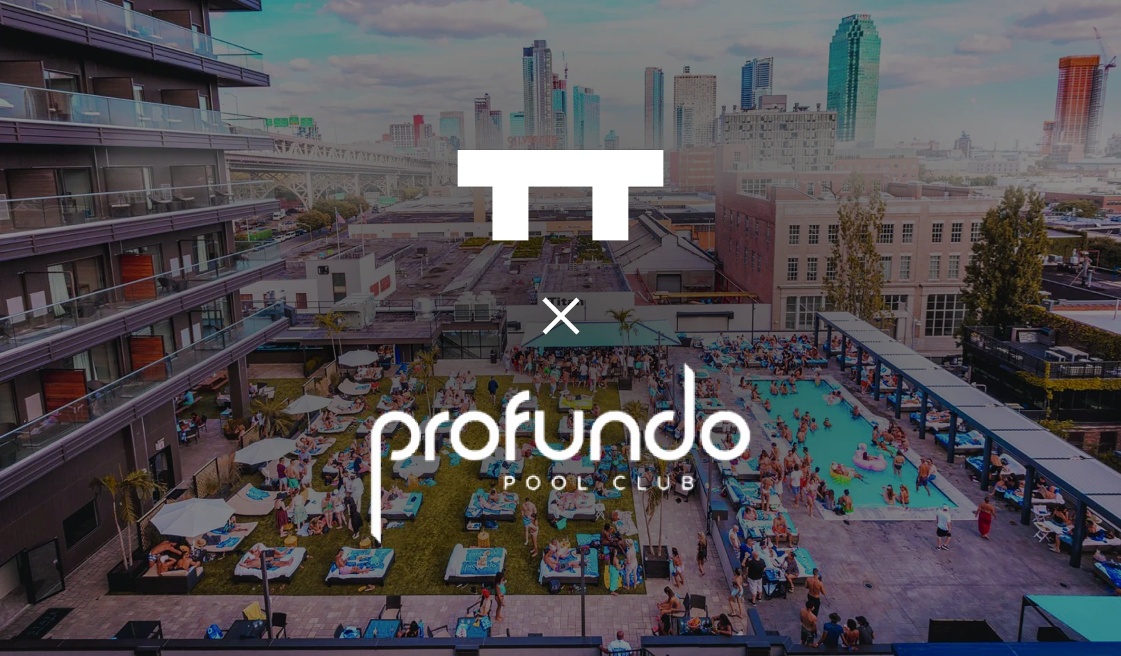 Crowded rooftop pool area at Profundo Pool Club with sunbeds, umbrellas, and city skyline in background.
