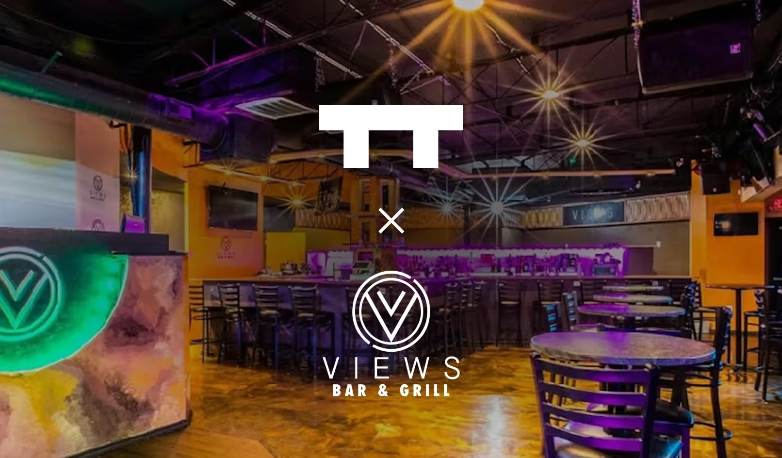 Interior of Views Bar & Grill with empty tables, bar stools, and ambient purple lighting.