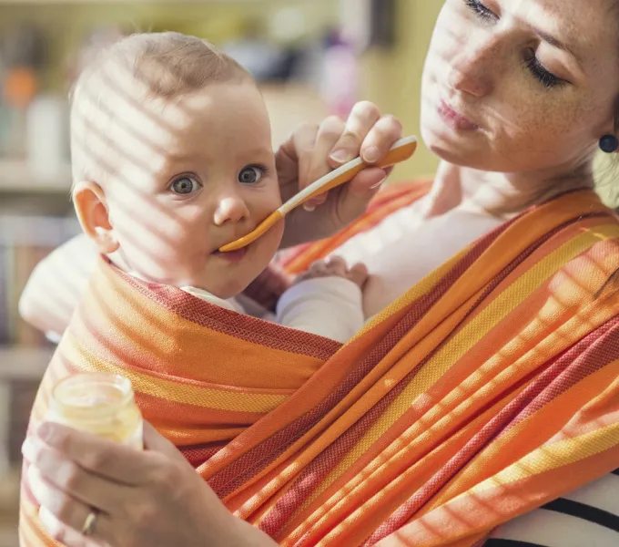 Mother with baby in baby carrier.
