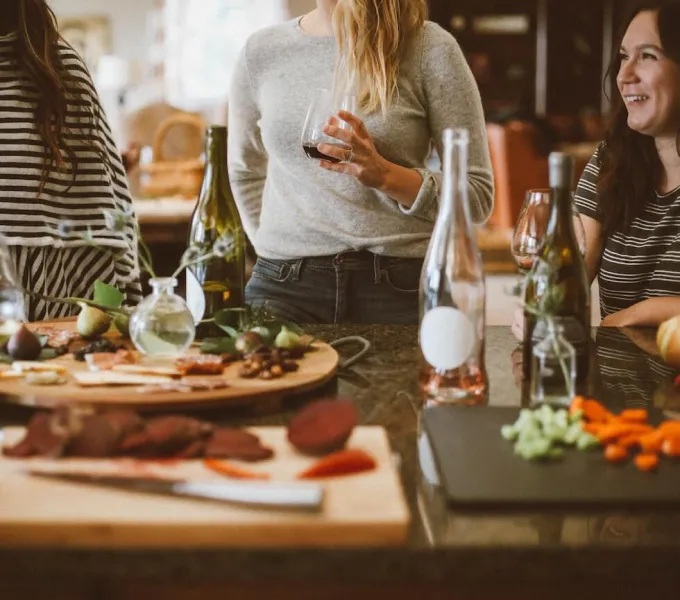 Women talking about their pelvic floors at a holiday gathering.