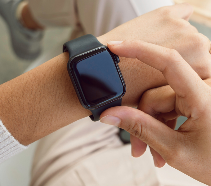 Person wearing an Apple Watch wearable, representing How to Use Health Trackers for Pelvic Health