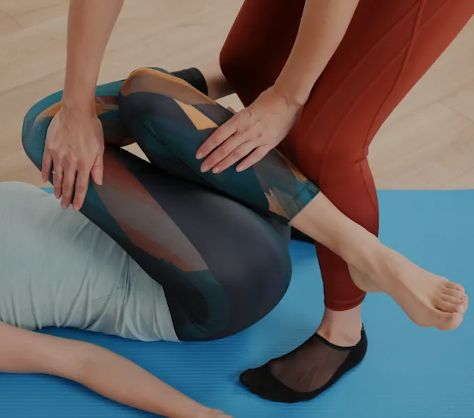 Woman receiving physical therapy care from a licensed provider, representing PT for hemorrhoids.