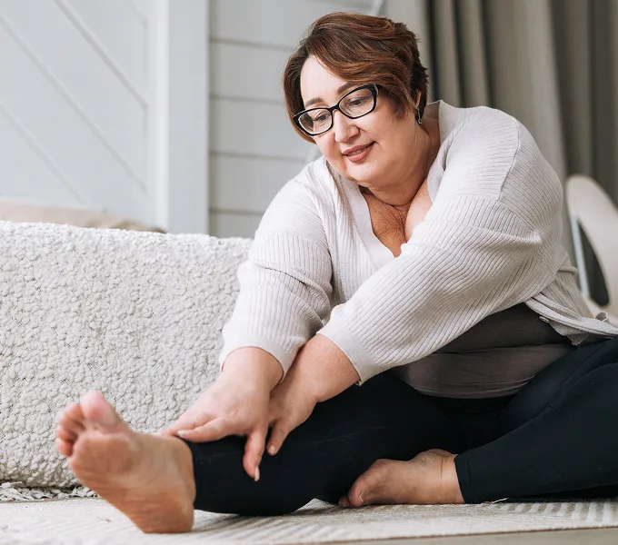 Mature woman doing exercises for her pelvic floor physical therapy appointment.