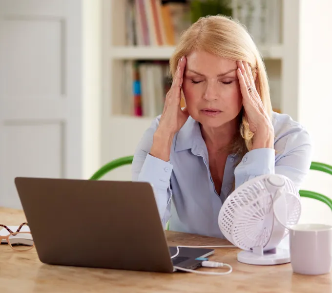Woman experiencing menopause symptoms.