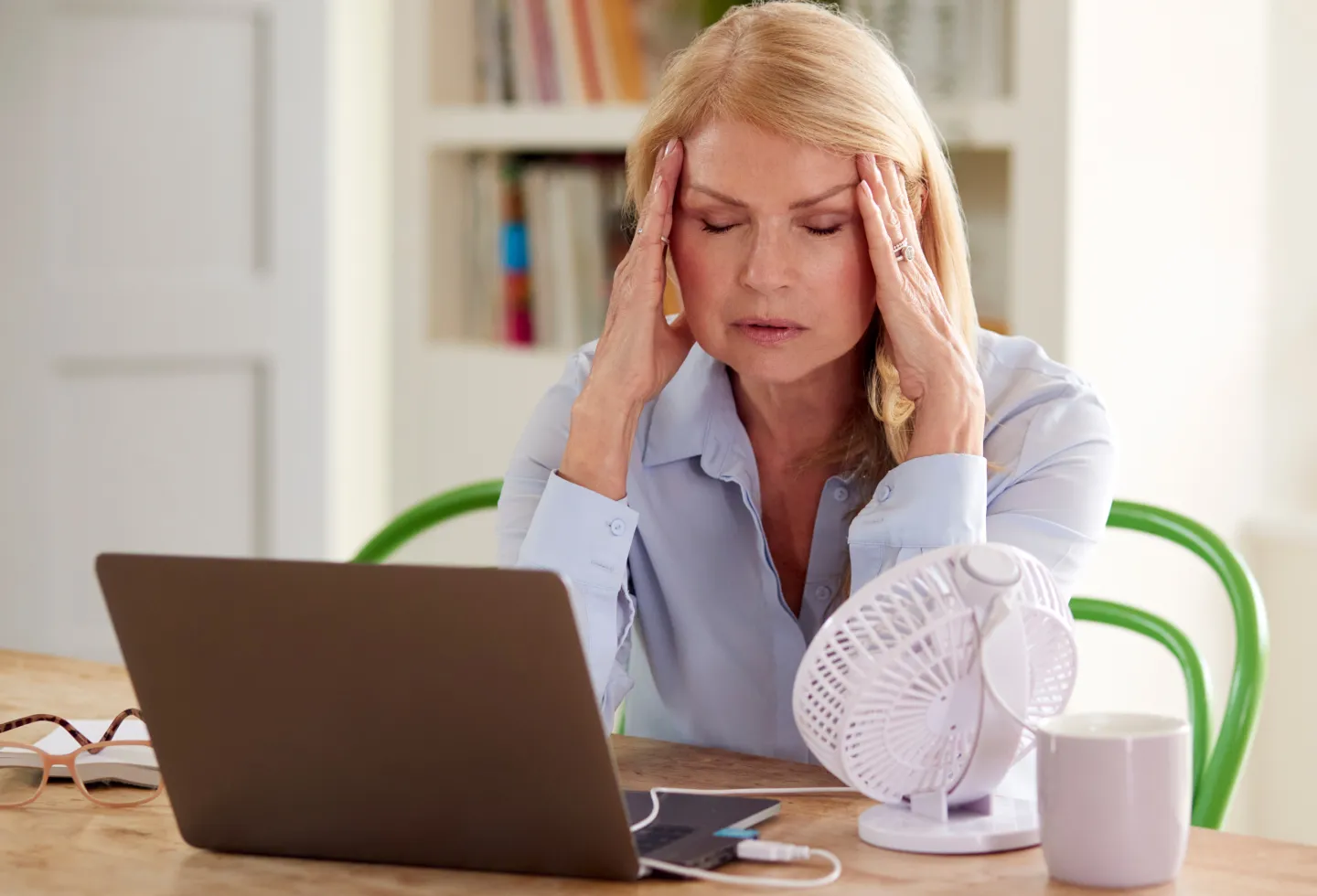 Woman experiencing menopause symptoms.