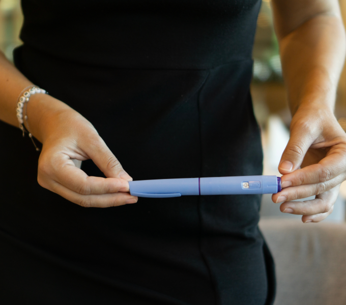 Woman holding GLP1 representing Ozempic for fertility