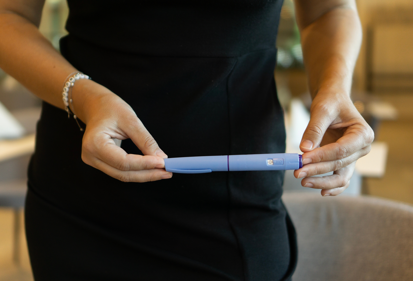 Woman holding GLP1 representing Ozempic for fertility