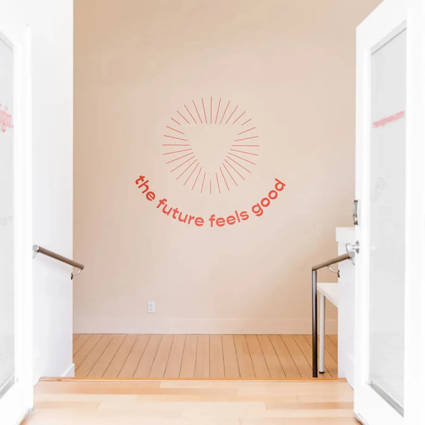 Uplifting wall art featuring the words “the future feels good” at Origin’s West Hollywood clinic.
