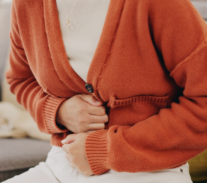 Woman with IBS and pelvic floor dysfunction experiencing bloating