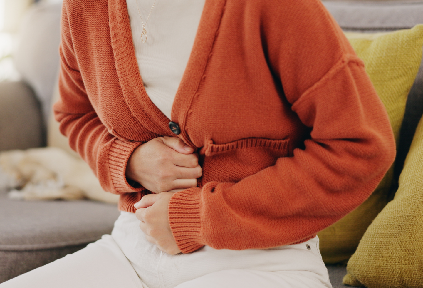 Woman with IBS and pelvic floor dysfunction experiencing bloating