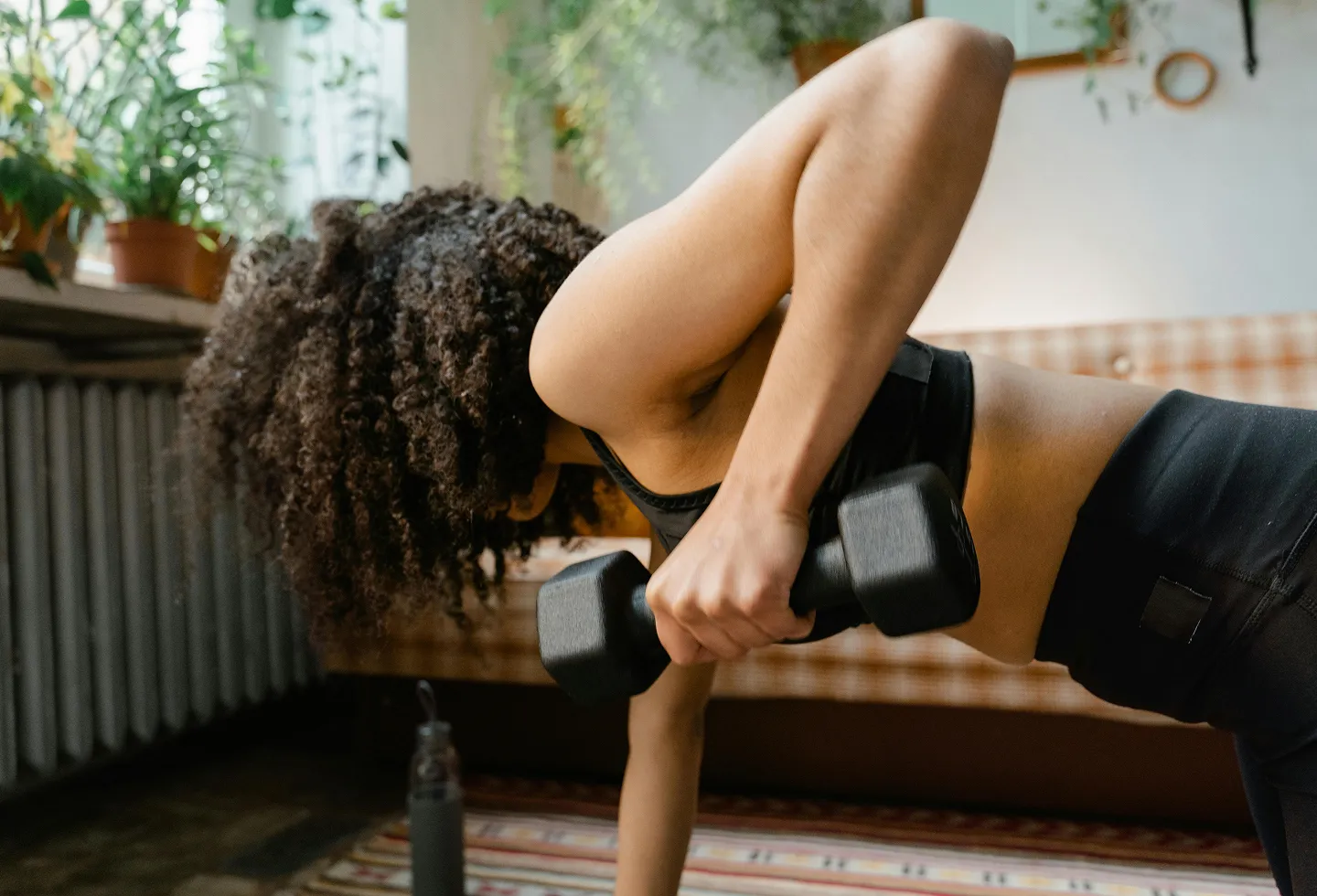 Woman doing strength training with weights represending women's health physical therapy and the 2026 strength training guidelines.